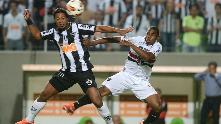 Ronaldinho of Brazil's Atletico Mineiro, left, fights for the ball with Wellington of Brazil's Sao Paulo FC at a Copa Libertadores soccer match in Belo Horizonte, Brazil, Wednesday, May 8, 2013