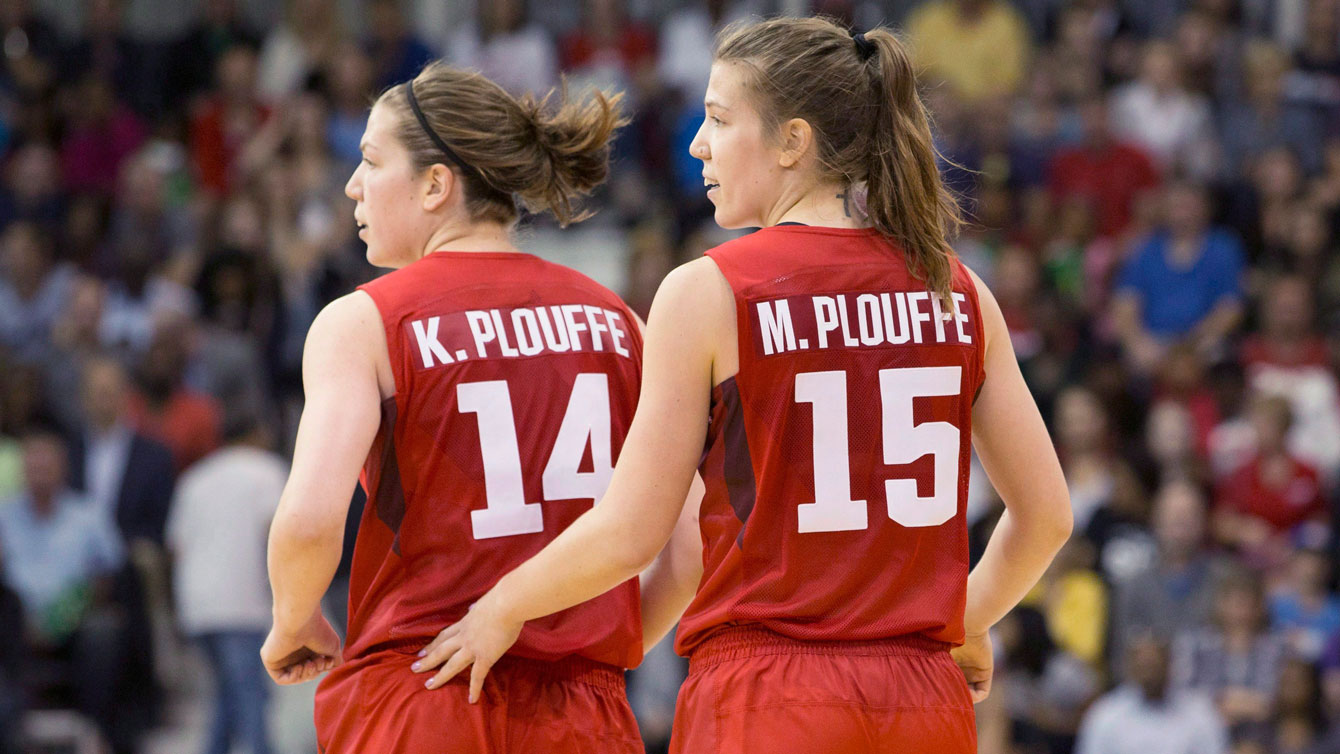 Michelle Plouffe (right) jogs back to her defensive position with sister Katherine during women's basketball action against Argentina at the Pan Am games in Toronto on Friday, July 17, 2015. THE CANADIAN PRESS/Chris Young
